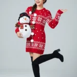 Female model wearing red Christmas dress holding Christmas gift box