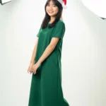 Female model wearing green Christmas dress