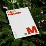 Free Laying Card Between Flowers Mockup