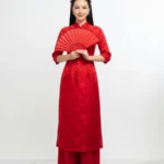 Model tết áo dài đỏ wearing a red ao dai for Tet 20012026a