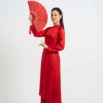 Model tết áo dài đỏ wearing a red ao dai for Tet 20012026b
