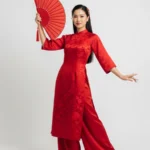 Model tết áo dài đỏ wearing a red ao dai for Tet 20012026d